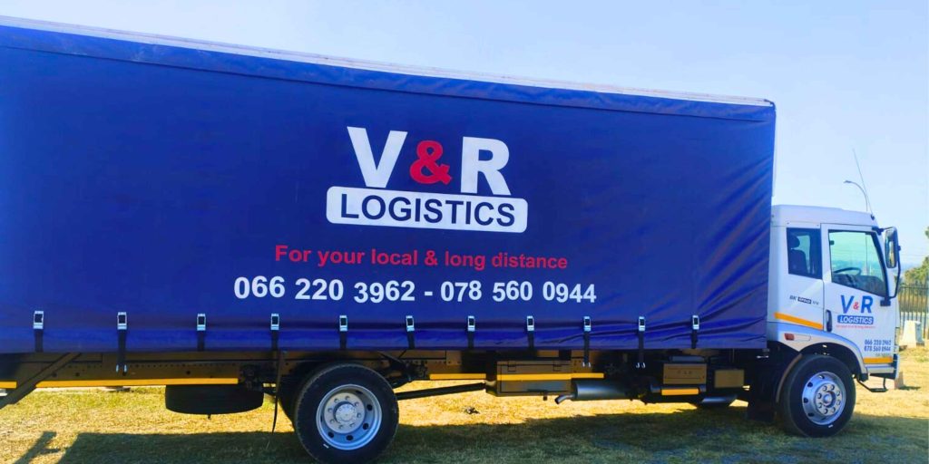 V&R Logistics truck with a blue cargo cover, featuring the 'V&R Logistics' logo, 'For your local & long distance' services, and contact numbers 066 220 3962, 078 560 0944.